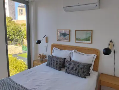 a bedroom with a bed with pillows and a window at Fontainhas Elite Apartments in Porto