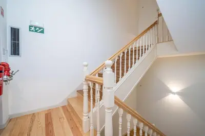 a staircase in a home with white walls and wooden floors at 31 de Janeiro Flat by Amber Star Rent in Porto