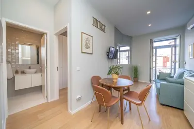 a kitchen and living room with a table and chairs at 31 de Janeiro Flat by Amber Star Rent in Porto