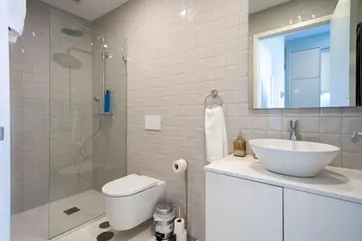 a bathroom with a toilet and a sink and a shower at 31 de Janeiro Flat by Amber Star Rent in Porto