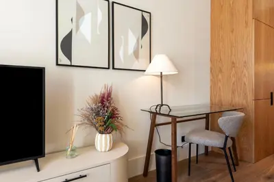 a living room with a desk and a tv at Ando Living - Santa Catarina House in Porto