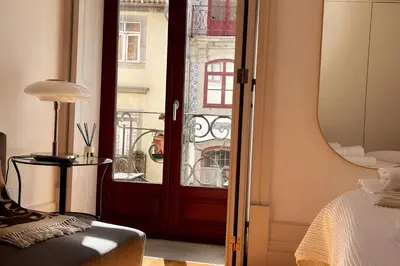 a bedroom with a door leading to a balcony at Historic Porto Balcony Hideaway - Taipas House 60 in Porto