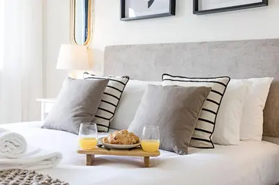 a coffee table with two glasses of orange juice on a couch at Santos Pousada 1071 by LovelyStay in Porto