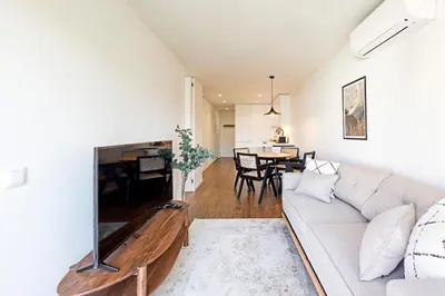 a living room with a couch and a dining room at Santos Pousada 1071 by LovelyStay in Porto