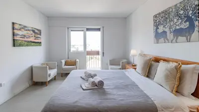 a bedroom with a large bed with towels on it at Central Gaia Apartment by Unique Hosts in Vila Nova de Gaia