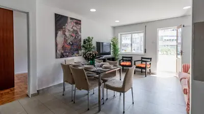 a kitchen and dining room with a table and a television at Central Gaia Apartment by Unique Hosts in Vila Nova de Gaia