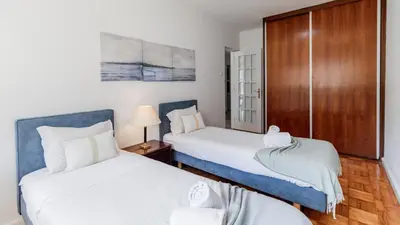 a bed with a pillow and a lamp on a nightstand at Central Gaia Apartment by Unique Hosts in Vila Nova de Gaia